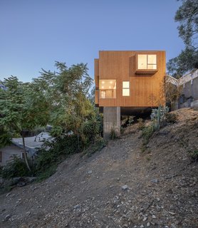 10 Gravity-Defying Cantilevered Homes - Photo 17 of 23 - Both the front door and garage are accessible from street level. The floor is cantilevered out over a concrete pile foundation and garden far below.