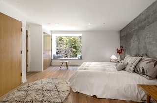 Twin Houses on Tiny Lots Stretch Outward for Space - Photo 4 of 9 - Inside, Storey chose to leave materials unfinished and as natural as possible — matte ceramic bathroom tiles, exposed concrete structural pillars and walls, and white-oak doors and floors. The latter were treated with WOCA, a VOC-free Danish floor oil.<br><br>"I left the concrete exposed to add texture — it’s a nice touch, because it’s something you’d normally see in much more high-spec houses," says Storey.