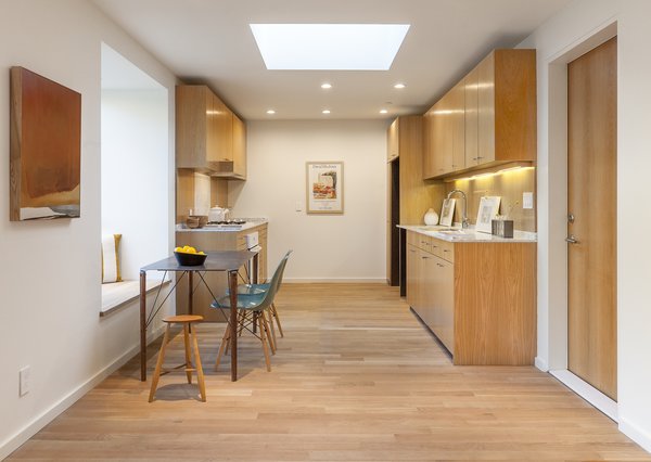 White oak was also used for the kitchen cabinetry, and white marble for the countertops. In the open-plan dining area, another window seat pulls double duty as a bench for the kitchen table.<br><br>"The bump-outs are designed to function as built-in furniture," he says. "I loved the idea of turning the walls into miniature habitable spaces, and making the house itself part of the furniture."
