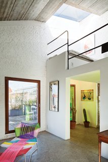 Use the loft to open up the space, not add clutter to it.<br><br>The raised loft floor gave us some wiggle room to add electrical outlets in the floor—under desks—to eliminate cords running across the work area floor. Our next challenge was how to get up to the loft area without taking up too much floor space on the first floor. The most modern and interesting way we found was to incorporate a spiral staircase. It required only a 40-inch diameter footprint—smaller than any other solution.