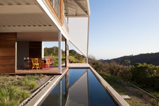 Striking Green House with a View in El Salvador - Photo 4 of 7 - The back patio overlooks a swath of forest.