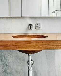 Breakfast Woodworks created the custom teak vanity in the master bathroom.