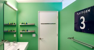 Renovating a Modern House in a Historic District - Photo 5 of 6 - Bright paint in the bathroom offsets the white living room. A transom brings natural light into the space. The faucets are Grohe Europlus.