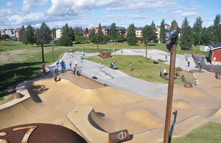 The design was assigned by a local skateboad club. They helped out finding the way to the junkyard of the steel factory, where all the old factory parts were collected for the park. A big ladle was placed on the highest part of the site to serve as a landmark and also a starting point to the pool feature that flows down to the main space. The materials are gray concrete, pigmented yellow concrete, gray granite, steel beams, and pipes and old factoryparts that are suitable for skateboarding and leisure.