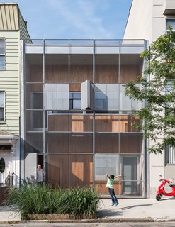 A Rooftop Garden Completes This Urban Pastoral Home - Photo 1 of 11 - The Baumann family residence in Gowanus, Brooklyn, is all geometry up front, with a rectilinear grid of steel and cypress comprising the structure’s double facade.