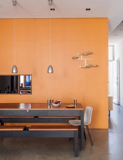 A Rooftop Garden Completes This Urban Pastoral Home - Photo 6 of 11 - Sheetrock surfaces comprise many of the interior walls, including one situated between the kitchen and dining area, which is furnished by benches and a table designed and built by Baumann, alongside HAL chairs by Jasper Morrison for Vitra.