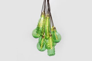 Product Spotlight: São Paulo Collection - Photo 2 of 3 - Studio Swine's hanging light pendants are crafted out of various glass beverage bottles. The clean and high quality glass is broken down into cullet, then each bulb is specifically formed and fitted and accented with brass fittings.