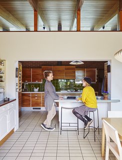 Quirky 1970s House in the English Countryside Showcases an Amazing Modern Furniture Collection - Photo 5 of 18 - Louise Jenkins, left, chats with her daughter, Freya, who sits on a powder-coated Slatted bar stool by Jasper Morrison manufactured in Lancashire.