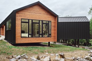 The metal and cedar cladding, inspired by a nearby zinc mine, continues seamlessly onto the house’s roof for a minimalist shed effect. "The drip edge turns to make the wall," explains architect Brandon Pace, "but changes above the window to accommodate a downspout. Any place where the metal contacts glass, or where you walk underneath, we have an internal gutter."
