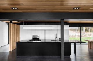 10 Stunning Ways to Use Black in Your Kitchen - Photo 6 of 10 - The kitchen’s black countertops were cut from Nero Assoluto granite. The sink and faucet are from Quebec-based company Rubi. Appliances are from Wolf.
