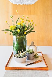 Full Bloom<br><br>The white Vico Magistretti dining table is a focal point when you enter the house--"and a great spot to create assemblages of some of my favorite objects," says Neely, who changes the display every few weeks. Set atop a reversible Finn Juhl tray are ceramics from Heath and a Carl Auböck fruit knife with a cane-wrapped handle. Notes Neely:"I always keep a handful of tillandsia around--air plants soften and warm up the space."