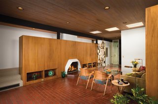 The living room features two side chairs and an end table by Edward Wormley for Dunbar and a bronze screen designed by Harold Balazs.