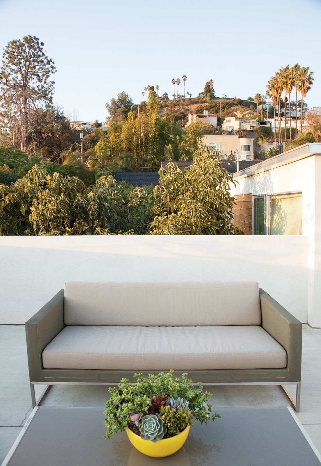 Jacobs transformed the roof into a series of decks, this deck features Crate & Barrel’s Dune sofa and coffee table.