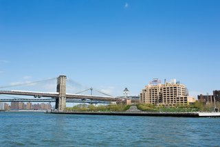 The Brooklyn Bridge Park’s greenery encroaches on the East River.