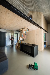 Given the spatial constraints, the staircase leading to the upstairs loft needed to be a short and steep. Since the residents wanted a workspace in the living area, the architects turned the underside of the stairs into a handy bookshelf.