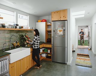 Abandoned Industrial Compound Becomes a Modern Home Base - Photo 3 of 11 - The kitchen features custom casework by Peter Doolittle, dark-green slate countertops from Hamilton-Schwarzhoff, and a Heath Ceramics backsplash.