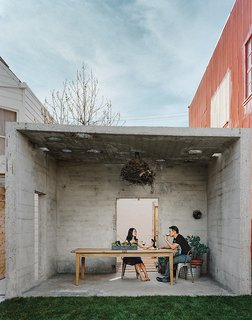 Abandoned Industrial Compound Becomes a Modern Home Base - Photo 10 of 11 - The couple uses the pavilion for outdoor dining. From there, the property opens to a small courtyard, and finally culminates at the main house, which holds one bedroom, a kitchen, a living-dining space, and a "flex" room.