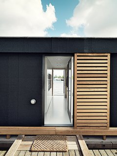 Outside, larch-wood shutters offer the residents privacy. 