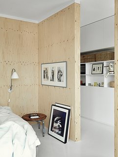 The sparsely decorated room features a PK33 stool, DUX bed, and framed photo of Björk by Anton Corbijin. 
