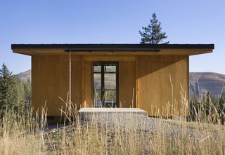 Deep eaves prevent the entrance from being buried in snow. The clients can see directly into the valley and mountains below.