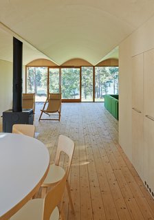 This Island Retreat Practically Embodies Simple, Rugged Scandinavian Design - Photo 2 of 4 - The first floor contains communal rooms (kitchen, living room, etc.) and private sleeping spaces are located above. The dining room table and chairs are from Artek.