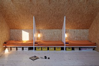 This Island Retreat Practically Embodies Simple, Rugged Scandinavian Design - Photo 3 of 4 - To keep expenses low, the architects opted for a simple gabled design and uncomplex materials—the sheet metal facade and OSB walls within, for instance.
