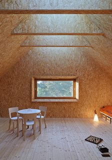 This Island Retreat Practically Embodies Simple, Rugged Scandinavian Design - Photo 1 of 4 - Glulam beams keep the interior column free and enable a large skylight that runs the length of the roof.