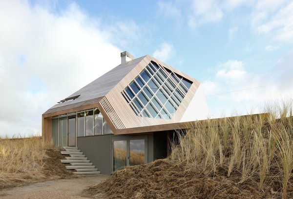 Using prefabricated materials for the exterior allowed Koehler and his team to drastically reduce building time during the construction phase. Cross-laminated timber panels (CLT), laser cut in the factory and assembled at the site within two weeks, add structure and aesthetic interest to the top of the home. Photo 3 of Dune House modern home