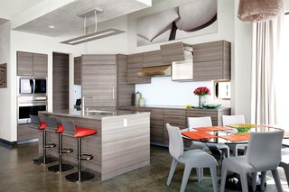 Cranston collaborated with project designer John A. Turturro and builder Bryan Henson of Allen Associates on the 2,400-square-foot house. The architect of record is Larry Graves of Alliance Design Group. Eco-conscious materials were key: In the kitchen, Poggenpohl cabinets were chosen for their recycled wood content and for the company’s low-waste factory efficiency. The Sub-Zero Wolf refrigerator uses less energy than a 100-watt light bulb.<br><br>Roche Bobois Ublo barstools pull up to the kitchen island; a Reduced fixture from Louis Poulsen hangs above. The dining area features a Lunch Time dining table and Chabada chairs, also from Roche Bobois.<br><br>To learn more about the Cranston Residence project and its players, please visit www.3palmsproject.com