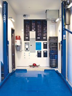 In the garage, a collection of smart-home technology is on display alongside a Bendpak Auto Lift, which builder Bryan Henson calls "an integral part of the house’s design: With the lift in place we met the county’s requirements for two covered parking spaces in a narrower garage bay. This freed up nearly 400 square feet of precious floor area on the other side of the house to accommodate both a mechanical room and a media room on the first floor."<br><br>Other mechanisms include a Broan whole house vacuum system that keeps the indoor air free of dust and allergens; a Lutron HomeWorks system that controls lighting and shades; an ELAN g! home system that controls irrigation, lighting, and security; and an AM House home-entertainment rack.<br><br>To learn more about the Cranston Residence project and its players, please visit www.3palmsproject.com