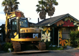 A "before" shot of the couple's original home before it was demolished to make way for the current residence. Says Cranston, "It was really fun—we called it the "love shack." But it truly outlived its purpose, and it was incredibly wasteful, energy-wise."<br><br>To learn more about the Cranston Residence project and its players, please visit www.3palmsproject.com