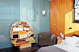 The master bedroom features a Chest of Drawers by Tejo Remy for Droog and a How High the Moon chair by Shiro Kuramata.