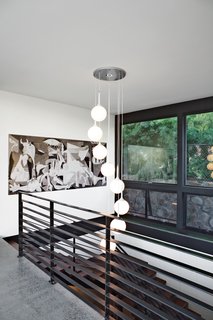 The First LEED Gold-Certified Family Home in San Diego - Photo 6 of 13 - Pink & Brown’s Corkscrew Pendant Lamp lights the stair leading to the family room