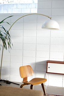 The First LEED Gold-Certified Family Home in San Diego - Photo 9 of 13 - The living room is populated with a molded plywood Eames chair and a vintage Italian lamp.