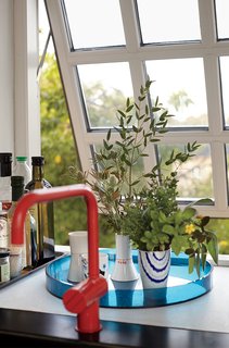 A Cramped Attic Became a Sunny Dining Room in this Renovation of a Copenhagen Tudor - Photo 7 of 12 - A red Vola faucet adds color, while the muntin bars on the windows recall the originals.
