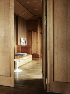 Take a Step Through 20 Huge Modern Doors - Photo 17 of 20 - The calf leather–upholstered banquette between the grand salon and the bedroom was designed by Perret and is original to the apartment; Claus likes to imagine that it’s where Perret would curl up for a nap.