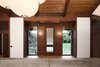 The building’s character is defined by the texture and color of its exposed wood. The clients wished to maintain this unique design feature and the architects worked extensively to repair and maintain the original ebony hues. The oak floors were refinished. The dark brown beams and columns are stained fir; they only required repairs on the exterior. The ceiling is cedar. Photo 2 of Zema Redux modern home