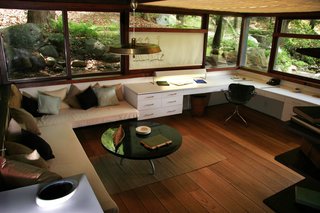 Wright's studio, enveloped by windows, sits at level with the landscape around it.
