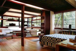 Wright's bedroom with his studio, seen just beyond through his bookshelves.