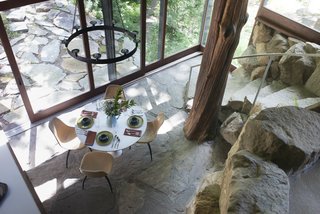 Wright's dining room and living area opened directly to an outdoor terrace. A massive tree trunk, seen center right, helps support the roof.