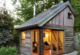 A polychrome facade made of salvaged, 100-year-old barnwood gives this small, lofted cottage space its unique character. Its copper roof is also reclaimed, a lucky Craigslist find from a local remodel. Though the structure has a footprint of just 11' x 14', it provides a useful space to entertain, catch up on work, or relax.