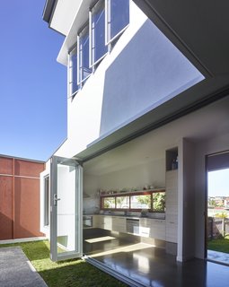 5 Sustainable Ways To Beat the Heat Without Air Conditioning - Photo 4 of 11 - By opening doors and windows on opposite sides of the house and on upper and lower floors, air can easily circulate through this home.
