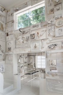 10,000 Bones Cover the Walls of this Mexico Restaurant - Photo 4 of 9 - "The pieces told us what they wanted to do on the wall," Cadena says. The menagerie of bones, including pieces from boar, turtles, and even a whale's vertebrae, are deliberately off-white, so it doesn't come across as too pure. The tables and chairs are separated from the walls, so diners aren't too distracted by the details of the elaborate, hand-made murals, which include silverware, serving utensils, and pieces from books.