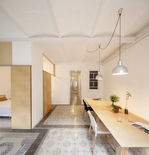 7 Historic Ceilings in Modern Homes That Have Been Beautifully Preserved - Photo 2 of 7 - A 1930s apartment in Barcelona was renovated by Adrian Elizalde, where the architect removed interior walls and an old plaster ceiling, revealing original masonry arch ceiling construction. Covered with a coat of white paint, the ceiling provides subtle texture and pattern to the smooth and neutral white and plywood walls.