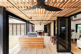A Modular Beach Home in Australia Allows One Family to Keep an Eye on the Surf - Photo 5 of 8 - An additional six weeks of construction were required on site to accommodate the large amount of decking and the two-car garage. Archiblox's David Martin said the toughest challenge of construction was the "double void area in the living room."