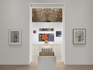 Andy Warhol at The Brant Foundation Study Center - Photo 8 of 15 - From Warhol’s famous hyper-color prints of hibiscus flowers (background), to his little known (unreleased) perfume collaboration (contained within the silver Coke bottles in front).<br><br>Credit Stefan Altenburger, Courtesy The Brant Foundation