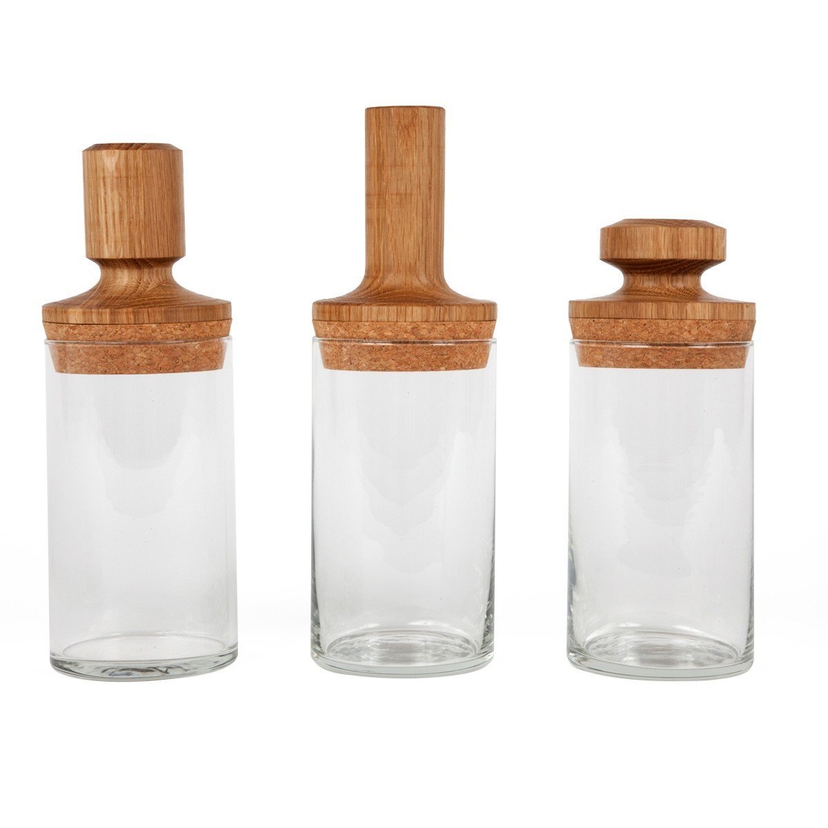 These Dry Goods Vessels from Fort Standard were originally designed to be used in the kitchen to store various dry goods, from coffee beans to pasta. The vessels can also be used in a modern bathroom, storing cotton balls, cotton swabs, and other essential items. Defined by its thin, cylindrical glass shape, each vessel is sealed with a large cork stopper with turned hardwood handles. The play of materials—glass, cork, and wood—creates visual interest to otherwise simple pieces.