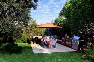 Branched aluminum dining chairs by Janus et Cie reference what Buckner calls the "magical forest" protecting the rear of the 13,000-square-foot lot.