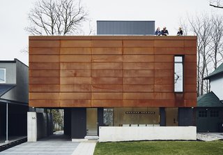The front facade features Cor-Ten steel fabricated by Praxy Cladding.
