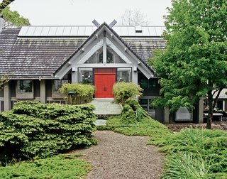 While Larsen’s home remains private, LongHouse Reserve’s 16 acres of carefully plotted gardens are open to the public from April through October. For Larsen, planting is a serious industry: "I figured out I could go away on weekends and garden without facing up to leisure." Flora includes wisteria around the front door.